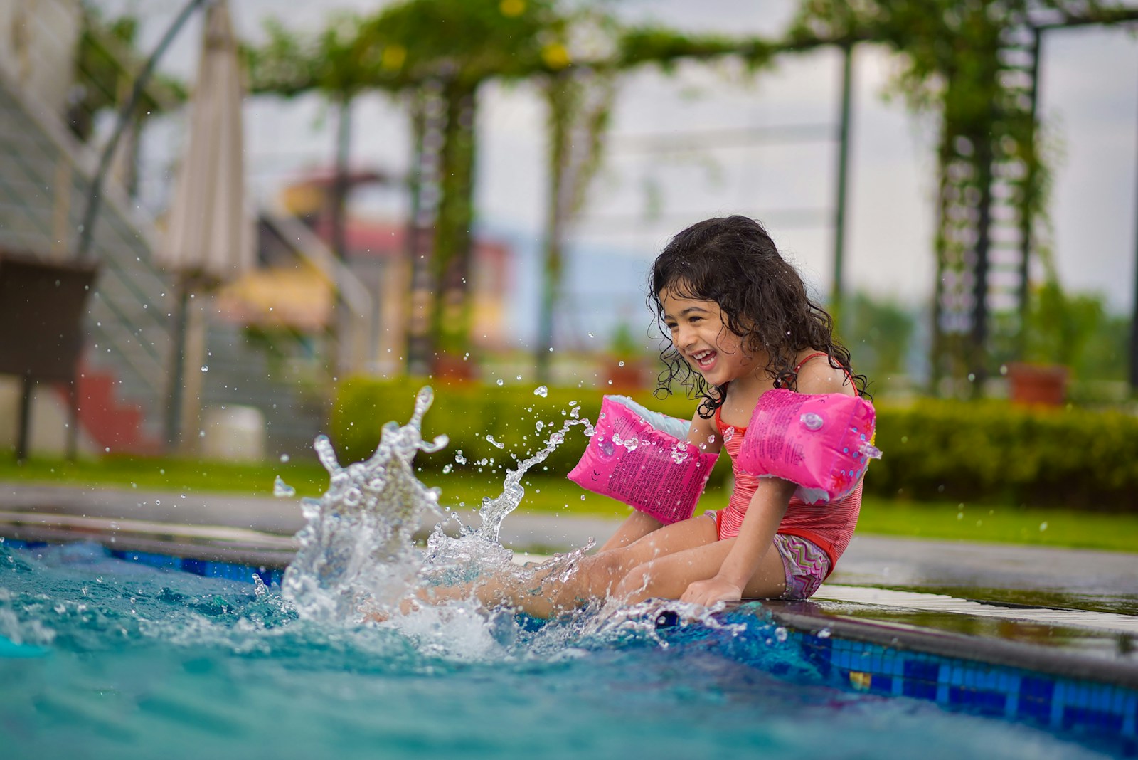 Photo by rajat sarki girl in pink shirt on swimming pool during daytime